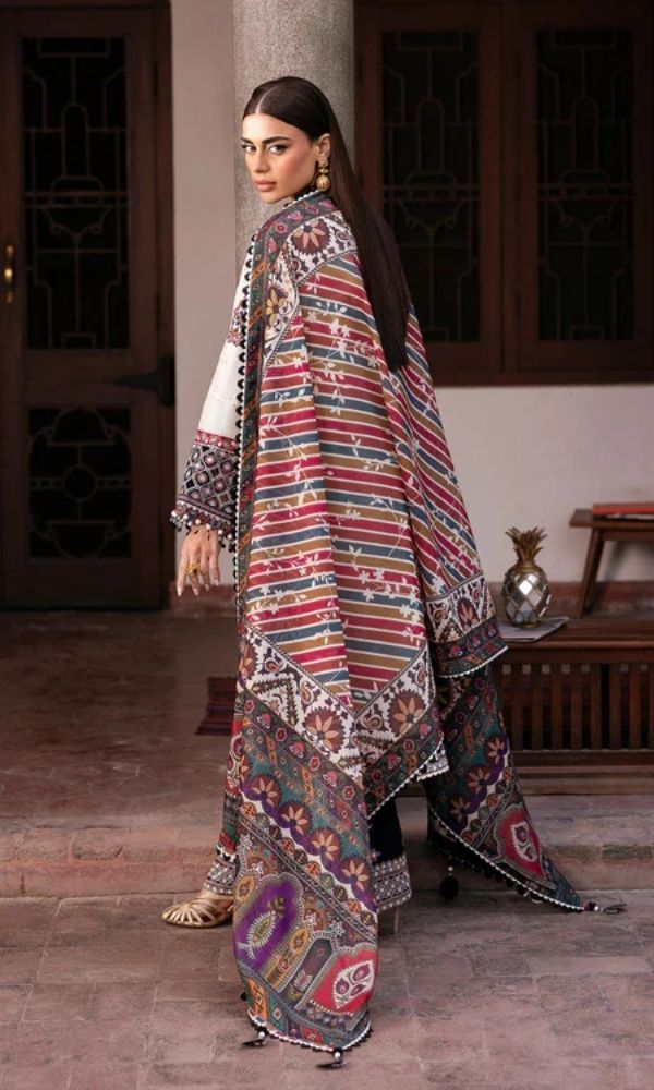 Model wearing a Jazmin Shahkaar cream-colored premium luxury lawn 3-piece suit featuring dark maroon and purple traditional geometric embroidery on wide-sleeves and pants, paired with a patterned multi-color digital print dupatta