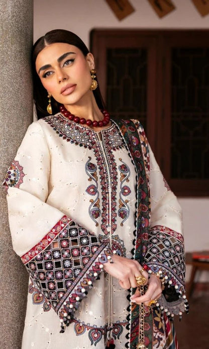Model wearing a Jazmin Shahkaar cream-colored premium luxury lawn 3-piece suit featuring dark maroon and purple traditional geometric embroidery on wide-sleeves and pants, paired with a patterned multi-color digital print dupatta