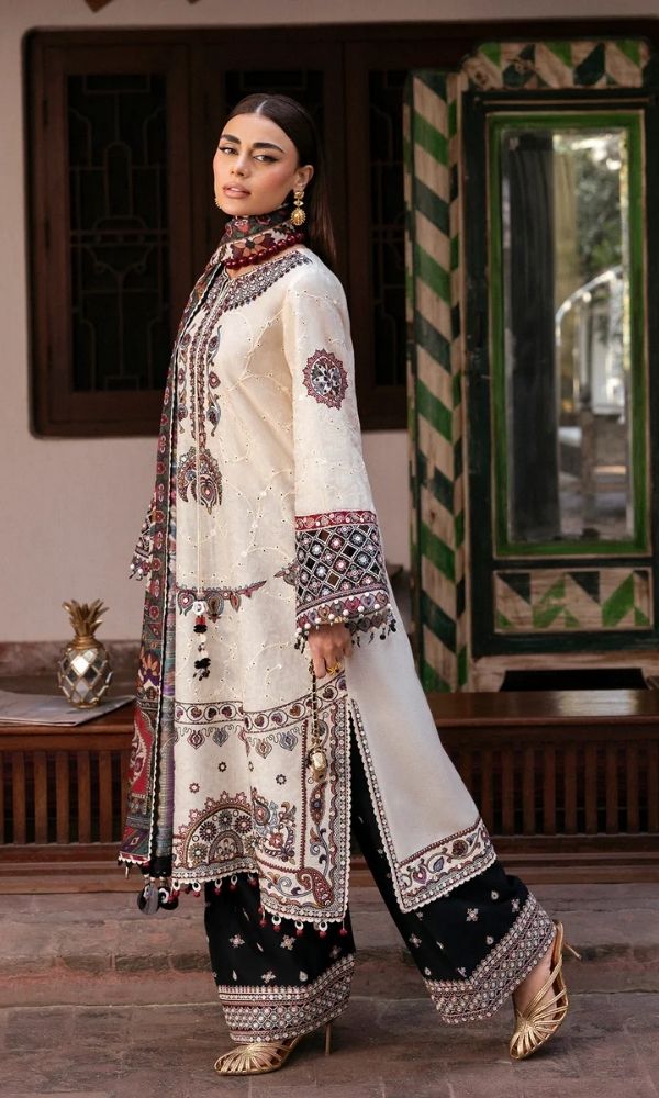 Model wearing a Jazmin Shahkaar cream-colored premium luxury lawn 3-piece suit featuring dark maroon and purple traditional geometric embroidery on wide-sleeves and pants, paired with a patterned multi-color digital print dupatta