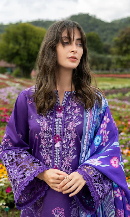 Woman wearing a purple embroidered outfit with a matching shawl in a garden setting